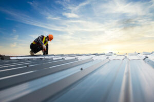 A man on the top of a metal roof in El Paso.